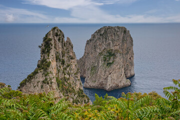 The Faraglioni Rocks located on the coast of Capri have always been one of the main attractions of the small island.View of the famous Faraglioni Rocks in the blue Tyrrhenian sea, Capri island, Italy