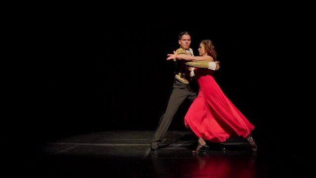 Pasodoble dance by ballroom dancing couple in spanish costumes on the stage