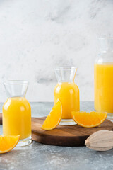 Glass pitchers of juice with slice of orange fruit