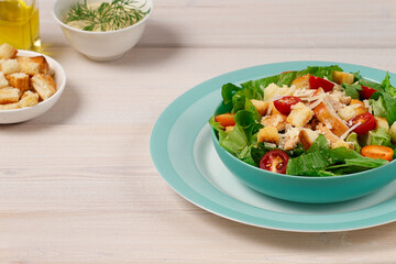 Caesar salad with chiken , on a white wooden table, top view, no people,