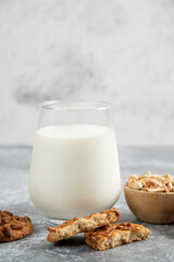 Cookies with organic peanuts and honey with glass of milk on marble background