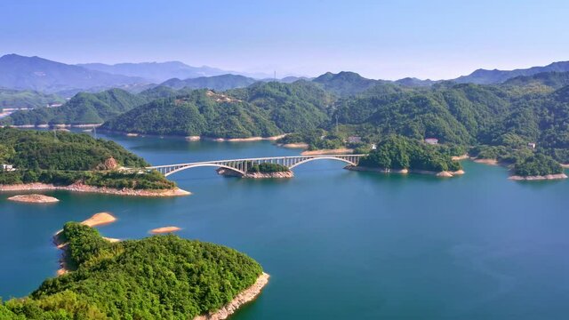 Rotating view of islands in the water, a bridge connecting mountains and overlapping mountains. Pretty landscape