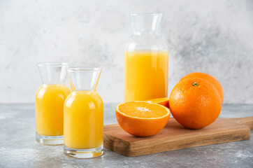 Glass pitchers of juice with slice of orange fruit