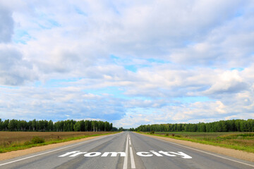 out of the city is written on the asphalt