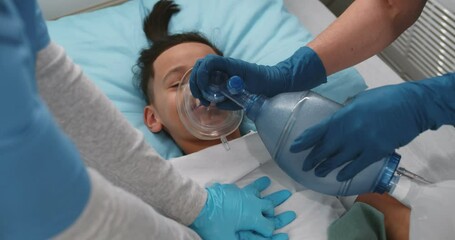 Close up of doctors doing cardiopulmonary resuscitation to preteen african kid