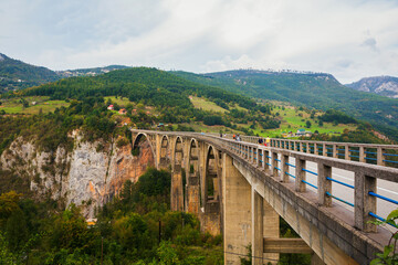Fototapeta na wymiar Concrete arch bridge Durdevitsa-Tara across the Tara deep river canyon, Montenegro.
