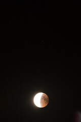 Lunar eclipse in the black night sky