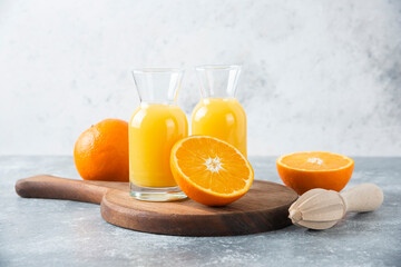 Glass pitchers of juice with slice of orange fruit