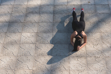 Photo of attractive woman in fashionable sportswear during workout. Sun spot. Sport and healthy lifestyle. Place for text.