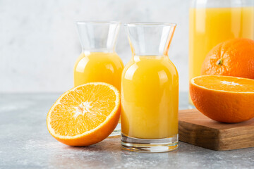 Glass pitchers of juice with slice of orange fruit