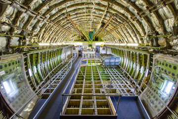 Inside view of a dismantled widebody airplane fuselage  - obrazy, fototapety, plakaty