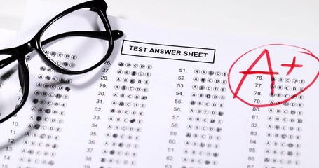 Final exam marked with A+ with red pencil. slow motion