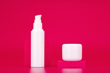 Face cream or gel and under eye serum or cream against pink background. Concept of daily skin care routine