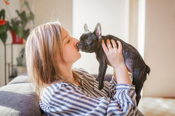 Portrait of happy adult at home with french bulldog