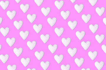 Pastel pink background with white hearts pattern. Minimal love art design.