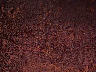 Uneven texture of cracked, weathered, faded, rotted flakes of rust on a sheet of iron. The...