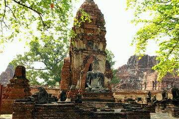 THAILAND AYUTTHAYA.  Wat Phra Mahatat, built in the 14th century, area dotted with small chedis and Khmer towers notably has a head of a Buddha statue where tree roots have grown around