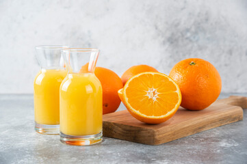 Glass pitchers of juice with slice of orange fruit