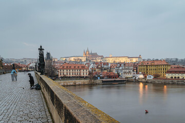 Fototapeta na wymiar Charlese bridge with Prague castle in the evening in the wintertime, Czech Republic