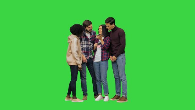 A group of friends checking some info with the voice commands on their phone, laughing at the search results on a Green Screen, Chroma Key.