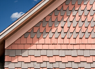Historic polychrome decorative shingle pattern on a New England house features rows of...