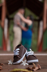 couple in love pregnant with baby shoes