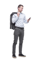 in full growth. smiling business man with a smartphone .