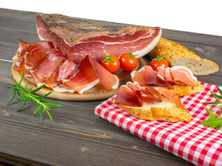 Still life of speck. Bread and slices of speck. Traditional smoked ham from south tyrol. Rustic...