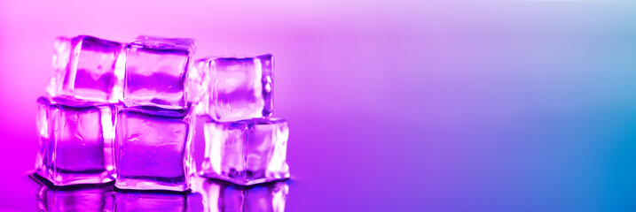 Ice cube. Close-up of melting ice cubes with pink and purple illumination on a black background. Macro horizontal photography