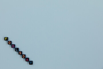 Text fools day folded of cubes with letters on a blue background