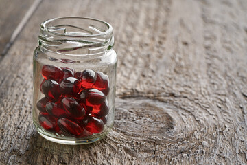Krill oil pills in a glass jar, with copy space