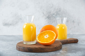 Glass pitchers of juice with slice of orange fruit