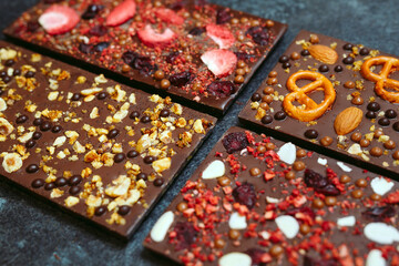 Handmade chocolate bars with a variety of dried fruit and nut toppings.