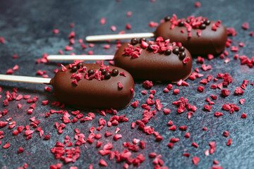 Chocolate bars are sprinkled with freeze-dried raspberries.