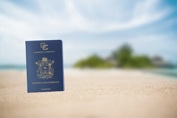 Antigua and Barbuda passport on the beach sand ,Space for writing