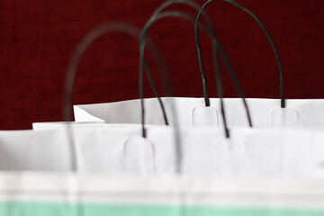 Conceptual photo of green and white shopping packages on colorful background