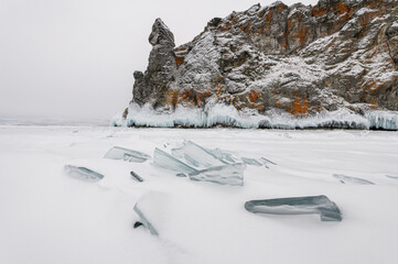 Snowy day on the lake in Siberia, Russia. Ice sheets on frozen lake Baikal.