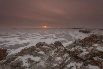 Sunrise on lake Baikal. Cold Russian winter in Siberia.