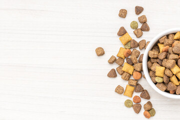 domestic pet dry food on wooden background. dried cat feed. above view