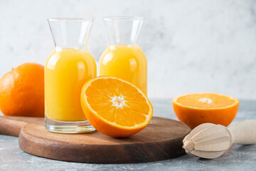 Glass pitchers of juice with slice of orange fruit