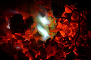 Lumps of magnesium burn with a bright white light on a burning anthracite coal.