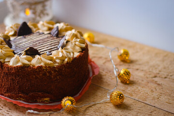 Delicious chocolate cake covered with chocolate chips and topped with a buttercream decoration