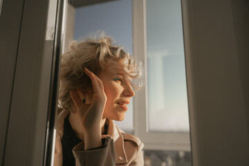 girl with curly hair eavesdrops on what goes through the glass door