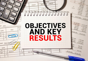 Objective Key Results OKR text in the office notebook. View from above