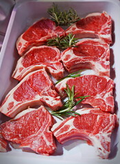 Raw lamb chops on a tray in an Italian butcher shop