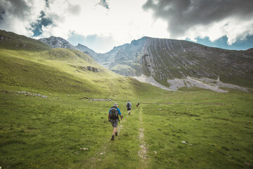 Fototapeta na wymiar Hikers with backpacks hiking in the mountains