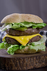 double cheeseburger on a wooden board