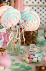 Delicious candy bar with sweets and swirl candies for kids birthday or other celebration. Sugar in diet. Pastel colors at party decoration.  