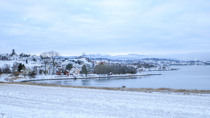 A town along the fjord on a snowing day. A very cold day at Ranheim, Trondheim, Norway.