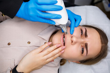 Laser removal of permanent makeup on the face. Close-up of a young woman getting tattoo correction....
